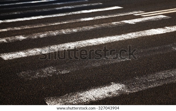  
photographed old worn road markings. asphalt
road