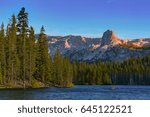 Photographed on Lake Mary Road in the city of Mammoth Lakes, California is when this view of the Lower Twin Lakes can be seen. A clear view of large pine trees, lake water, and of mountains. 