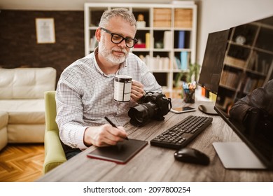 Photographer with beard, while working in his office at home. - Powered by Shutterstock