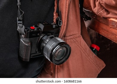 Photographer Camera Pending On His Neck. Reflex Photo And Camera. Brown Jacket.