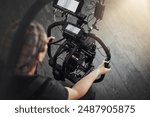 Photographer, camera and shooting with stabilizing rig on set for photography, media and magazine. Cameraman, focus and person backstage for filming, production and equipment as director with lens