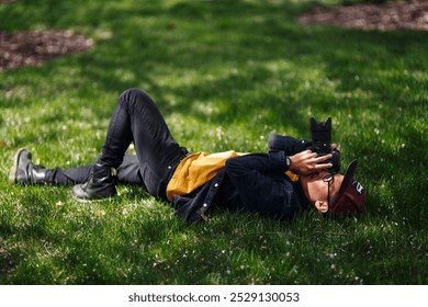 Photographer Capturing Moment While Lying On Grass - Powered by Shutterstock