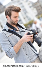 Photographer checking camera screen