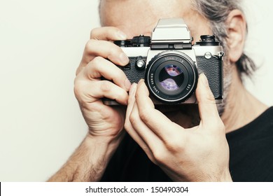 Photographer. Close Up Portrait Of Man Holding Vintage Camera.