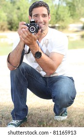 Photographer Crouching In The Countryside