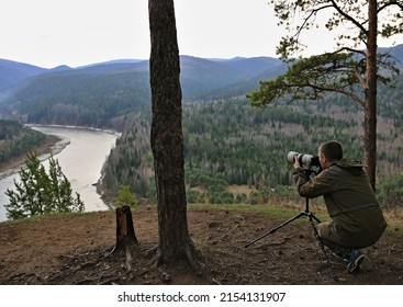 Photographer Filming Nature On A Camera With A Telephoto Lens