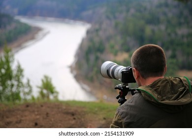 Photographer Filming Nature On A Camera With A Telephoto Lens