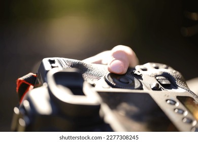 Photographer finger adjusting diaphragm aperture on camera dial - Powered by Shutterstock