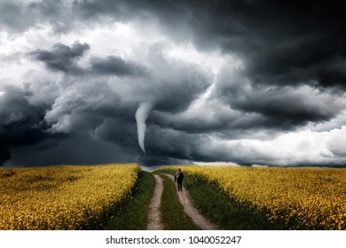 Photographer goes across the field towards storm - Powered by Shutterstock