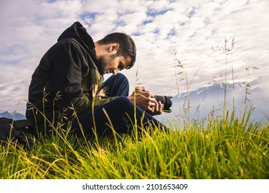 Photographer hand holding camera and Sitting on top of the rock in nature. Travel concept. Vintage tone. - Powered by Shutterstock