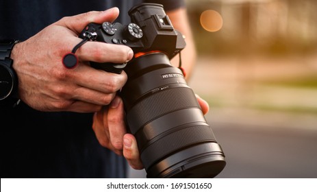 Photographer Holding a DSLR Camera