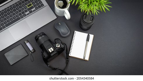 Photographer With Laptop  Dslr Camera On A Desk At Home.