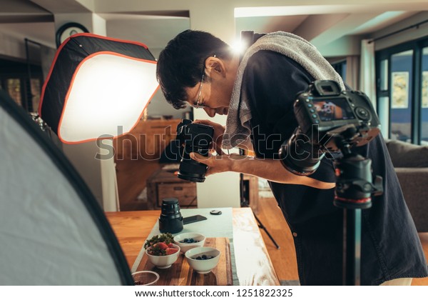 Photographer\
making vlog on food photography. in studio. Food photographer\
shooting food and recording video on\
camera.