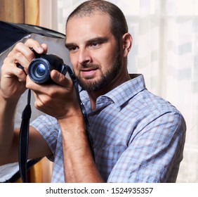 Photographer, a man with a camera in the process
