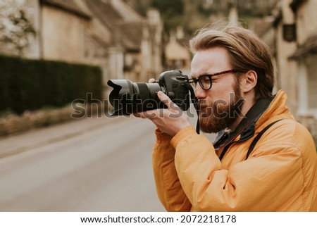 Photographer man taking photos in the village