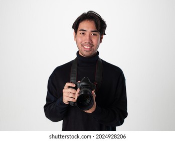 A Photographer Man Wear Black Turtle Neck Hold The Camera And Smile On White Isolate Background.