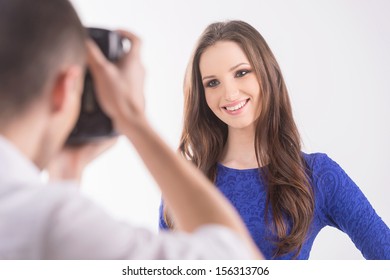 Photographer and model. Rear view of photographer shooting model at studio - Powered by Shutterstock