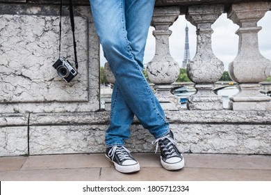 photographer on the background of the eiffel tower paris france feet with camera