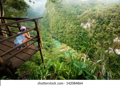 Photographer on the lookout point on the Cascades National Park in Guatemala Semuc Champey