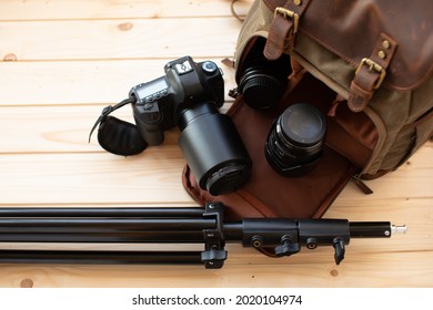 Photographer pack his camera and lenses to backpack. Bag appliances for photography.