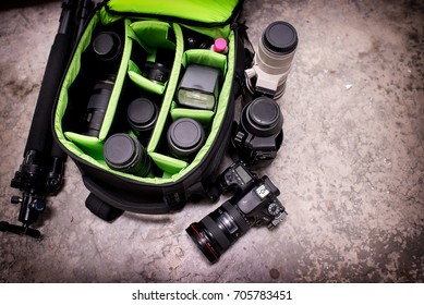 Photographer pack his camera and lenses to bagpack. Bag appliances for photography top view.