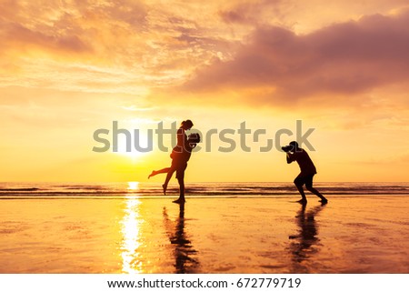 Photographer photographing a loving couple on the beach in summer