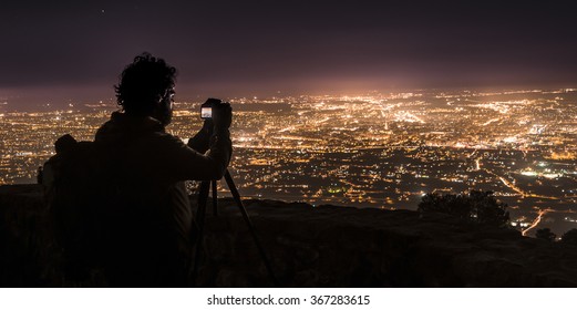 Photographer, photographing Murcia at night.Spain.