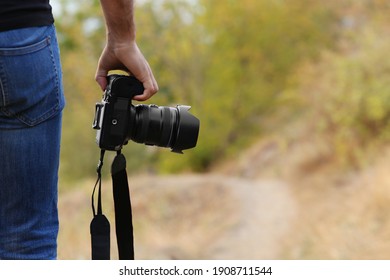 Photographer with professional camera in countryside closeup - Powered by Shutterstock