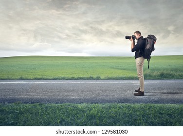 Photographer With Professional Camera On Desert Road