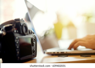 Photographer Retouching Photos On His Computer. Work In Progress After A Successful Photo Shooting.