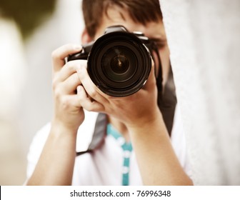 Photographer, selective focus point on nearest part of lens - Powered by Shutterstock