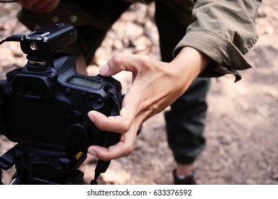 Photographer is setting a camera