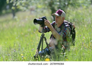 Photographer Shooting Nature Style Pictures In Country Field