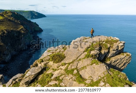 Photographer shooting the Valley of Rocks,  a dry valley that runs parallel to the coast in north Devon in Exmoor national park in England