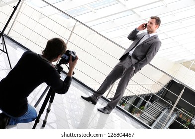 photographer shoots a business man with phone