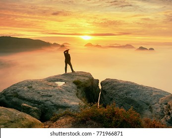 Photographer silhouette above a clouds sea, misty mountains.Gentle moving clouds in valley.