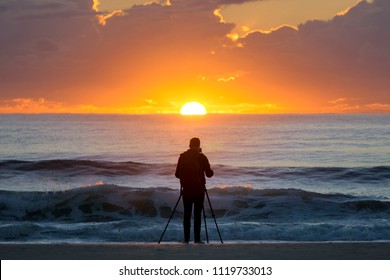 Photographer at sun rise - Powered by Shutterstock