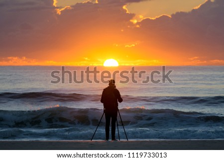 Photographer at sun rise