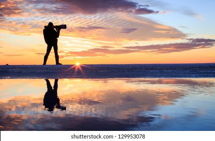 A photographer in sunset - Powered by Shutterstock