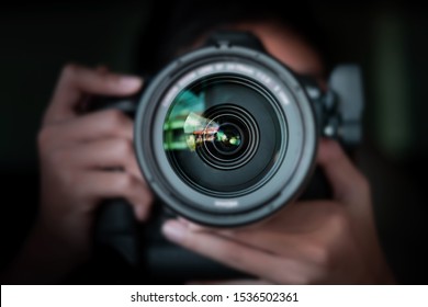 photographer  take pictures Snapshot with camera. man hand holding with camera looking through lens.Concept for photographing articles Professionally
