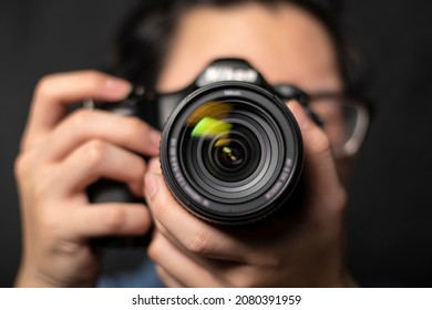 photographer take pictures Snapshot with camera. man hand holding with camera looking through lens.Concept for photographing articles Professionally. - Powered by Shutterstock