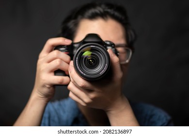 photographer take pictures Snapshot with camera. man hand holding with camera looking through lens.Concept for photographing articles Professionally.	 - Powered by Shutterstock