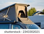The photographer takes pictures of the minivan camper. Spy with a camera in the car. A private detective is sitting in the car, filming.