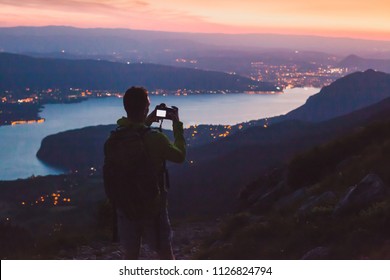 Photographer Taking Photo On Dslr Camera At Night After Sunset Twilights, City Panoramic Mountain Landscape Low Light, Dusk