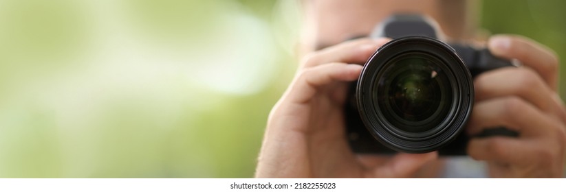 Photographer Taking Picture With Professional Camera Outdoors, Space For Text. Banner Design