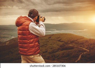 Photographer is taking a picture of  sunset in mountains - Powered by Shutterstock