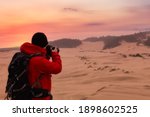 Photographer taking pictures of the beautiful landscape. Taken in Oregon Dunes National Recreation Area, Reedsport, Oregon Coast, USA. Sunrise Sky Art Render