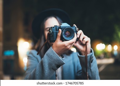 Photographer Tourist Girl With Retro Camera Take Photo On Background Bokeh Light In Evening City, Blogger Photoshoot Photo Hobby