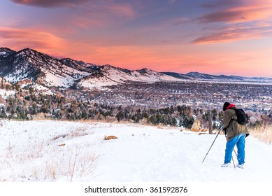 Photographer With A Tripod During The Winter A Sunrise Near Boulder, Colorado In The Mountains.