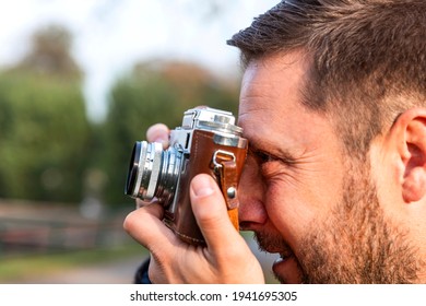 Photographer with vintage analogue film camera outdoors  - Powered by Shutterstock